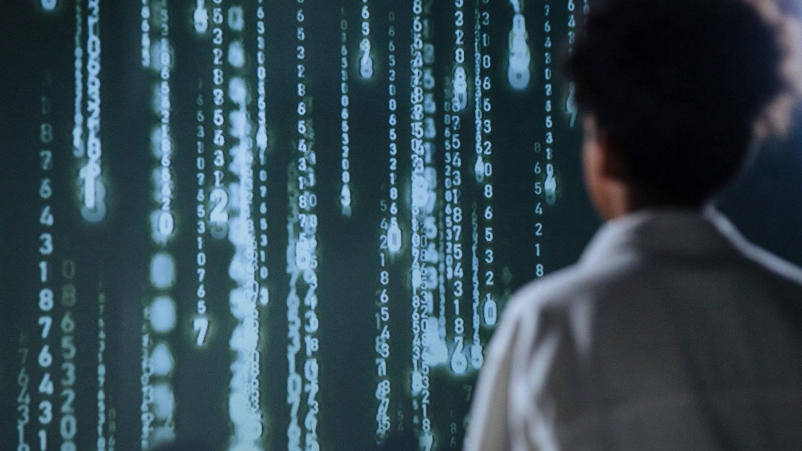Person looking at falling digital code.